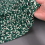 Ткань вискоза зеленого цвета с черно-белым принтом